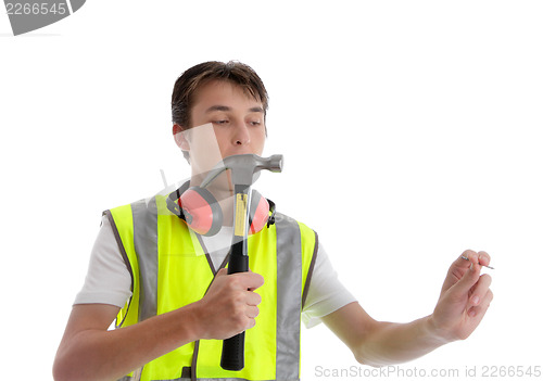 Image of Teen apprentice with hammer and nail