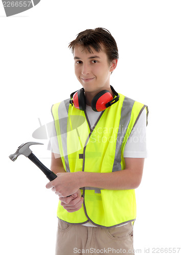 Image of Young teen apprentice builder holding hammer