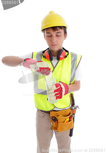 Image of Young builder drinking a bottle of water