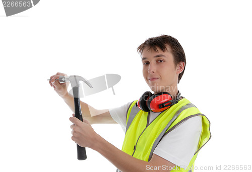 Image of Teenager using a hammer and nail