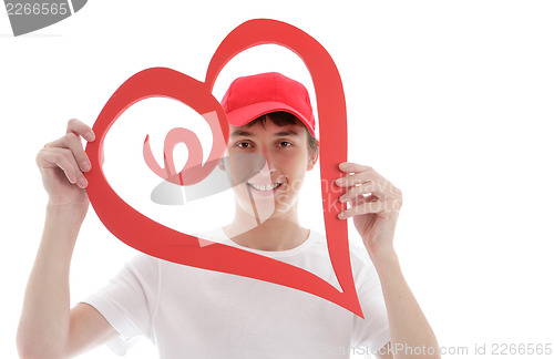 Image of Teen looking through a red love heart