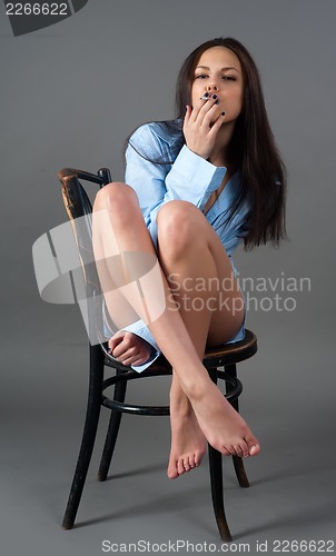 Image of beautiful young brunette woman with cigarette