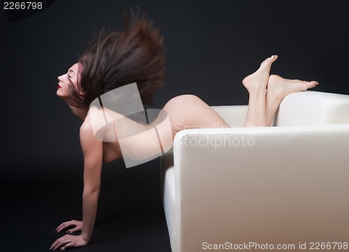 Image of beautiful naked woman on a sofa