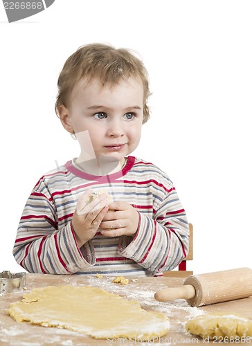 Image of happy young child with rolling pin in white background