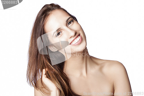 Image of Happy woman touching hair