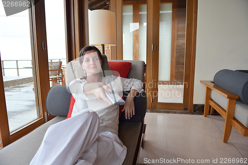 Image of happy young woman relax at home on sofa