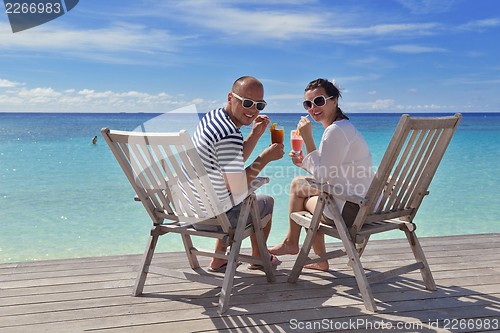 Image of happy young couple relax and take fresh drink