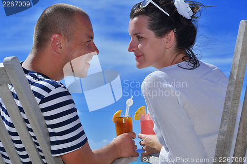 Image of happy young couple relax and take fresh drink