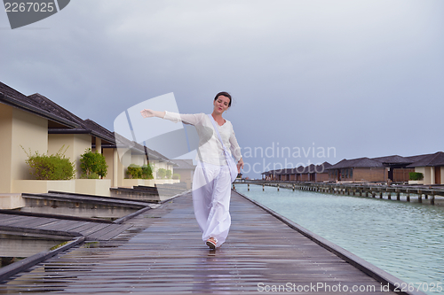 Image of young woman relax on cloudy summer day
