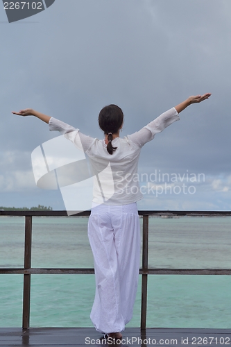Image of young woman relax on cloudy summer day