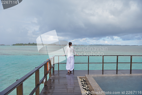Image of young woman relax on cloudy summer day