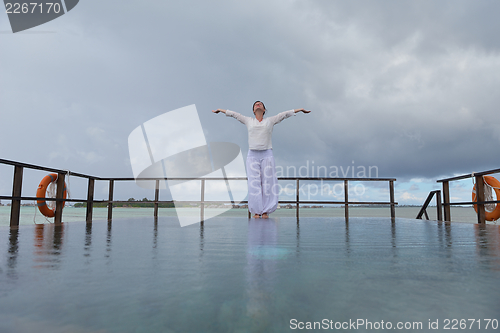 Image of young woman relax on cloudy summer day
