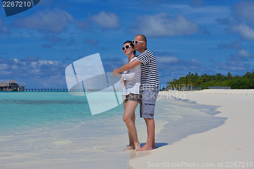 Image of happy young  couple at summer vacation have fun and relax at bea