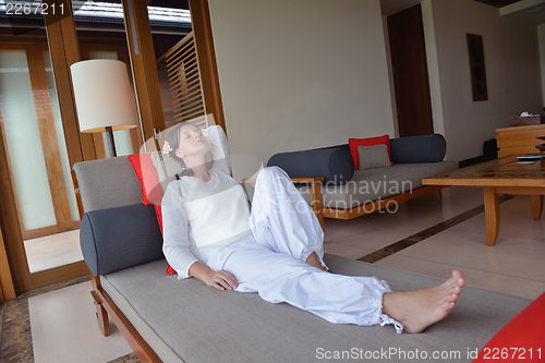 Image of happy young woman relax at home on sofa