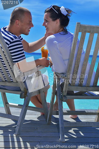 Image of happy young couple relax and take fresh drink