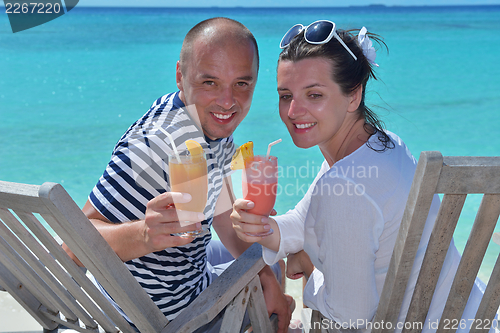 Image of happy young couple relax and take fresh drink