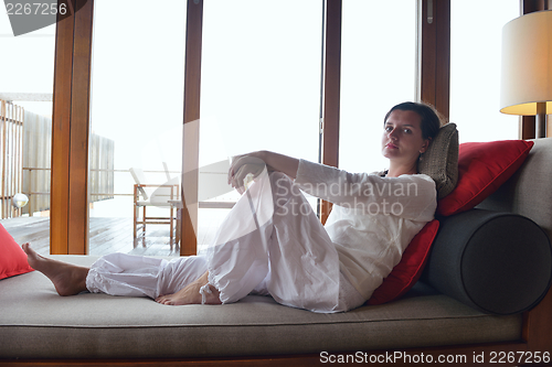 Image of happy young woman relax at home on sofa