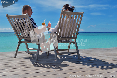 Image of happy young couple relax and take fresh drink