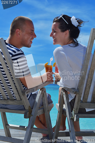 Image of happy young couple relax and take fresh drink