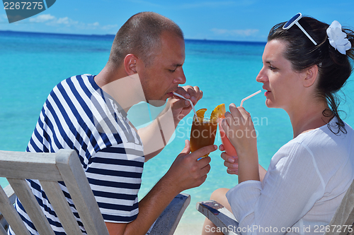 Image of happy young couple relax and take fresh drink