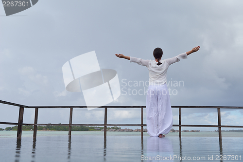Image of young woman relax on cloudy summer day