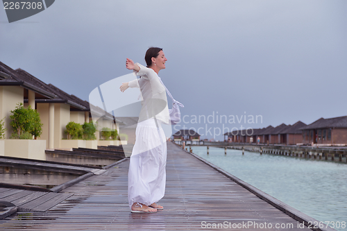 Image of young woman relax on cloudy summer day