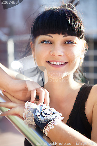 Image of face of beautiful young woman in black blouse