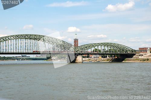 Image of A train crosses the Hohenzollernbruecke over the Rhine in Cologn