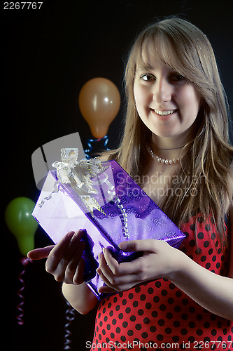 Image of smiling girl with a gift box