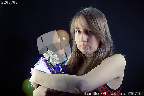Image of sad girl with a gift box
