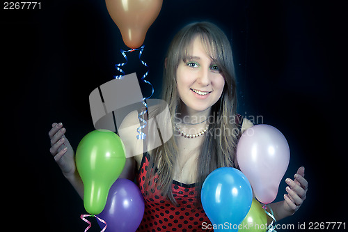 Image of  smiling girl with colorful balloons