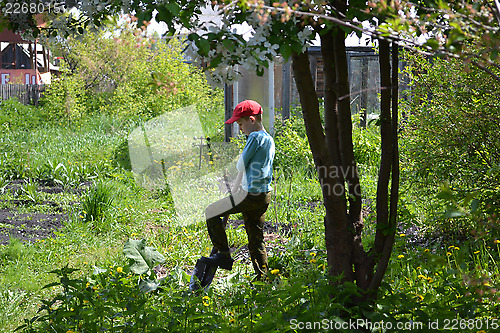 Image of the teenage boy with a shovel 