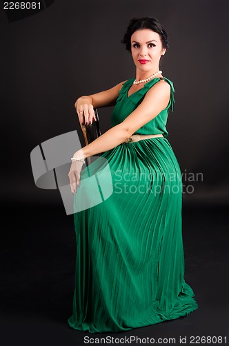 Image of pretty young woman sitting on chair