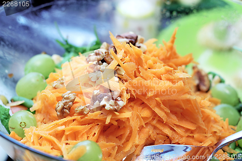 Image of carrot salad with nuts and grapes