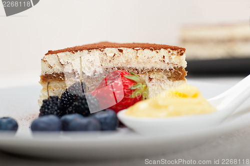 Image of tiramisu dessert with berries and cream