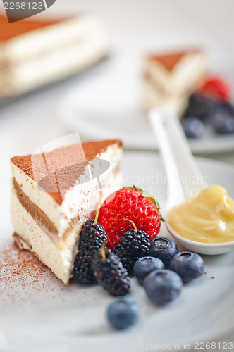 Image of tiramisu dessert with berries and cream