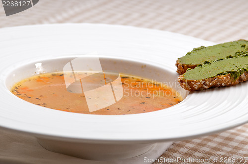 Image of Italian minestrone soup with pesto crostini on side