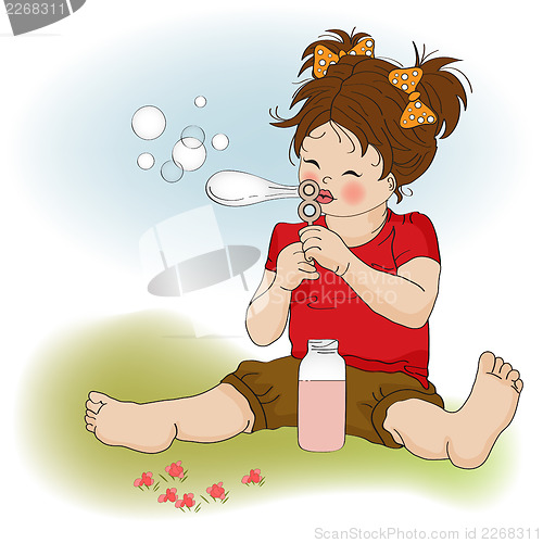 Image of funny lovely little girl blowing soap bubbles