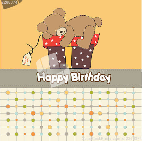 Image of birthday greeting card with teddy bear and big gift box