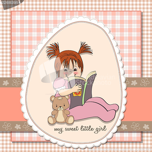 Image of sweet little girl reading a book