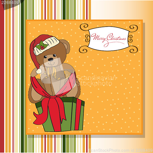 Image of cute teddy bear with a big Christmas gift box