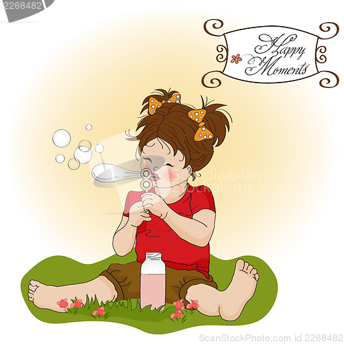Image of funny lovely little girl blowing soap bubbles