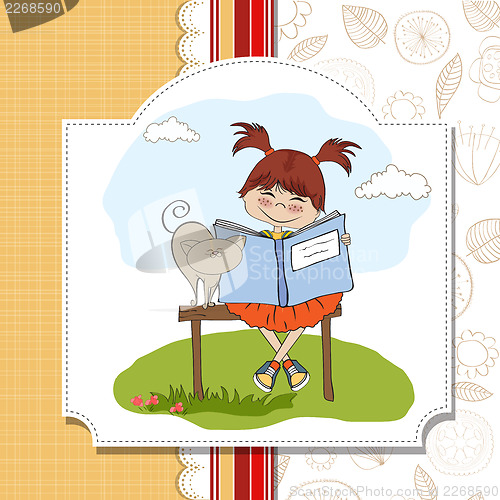 Image of young sweet girl reading a book