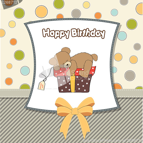 Image of birthday greeting card with teddy bear and big gift box