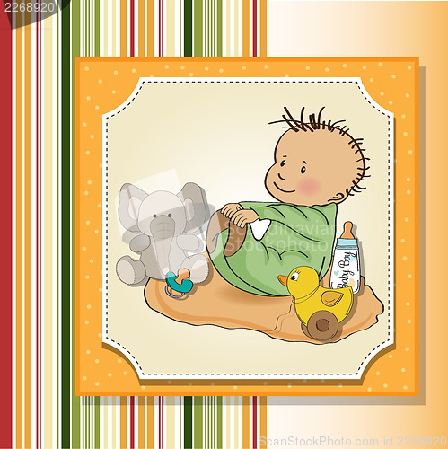 Image of little baby boy play with his toys