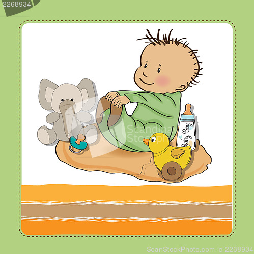 Image of little baby boy play with his toys