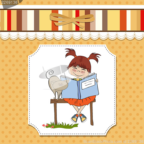 Image of young sweet girl reading a book