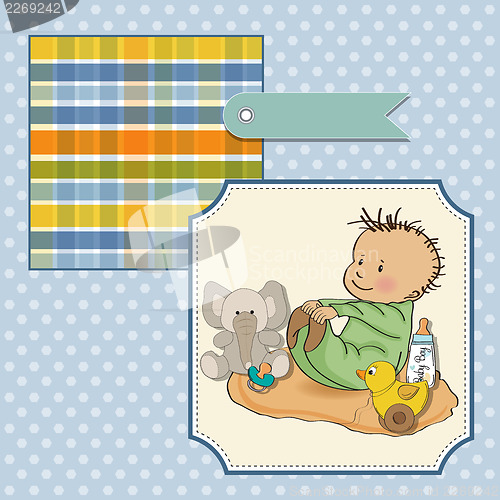 Image of little baby boy play with his toys
