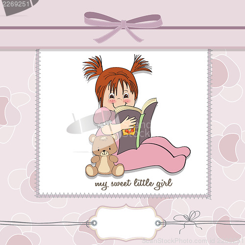 Image of sweet little girl reading a book