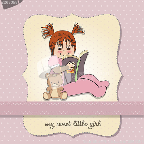 Image of sweet little girl reading a book